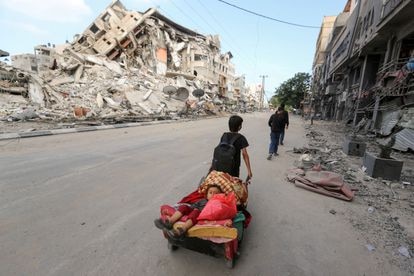 La victoria se aleja, el dolor aumenta 2 Un niño palestino transporta a otro en un carrito en Gaza, este pasado 14 de mayo.